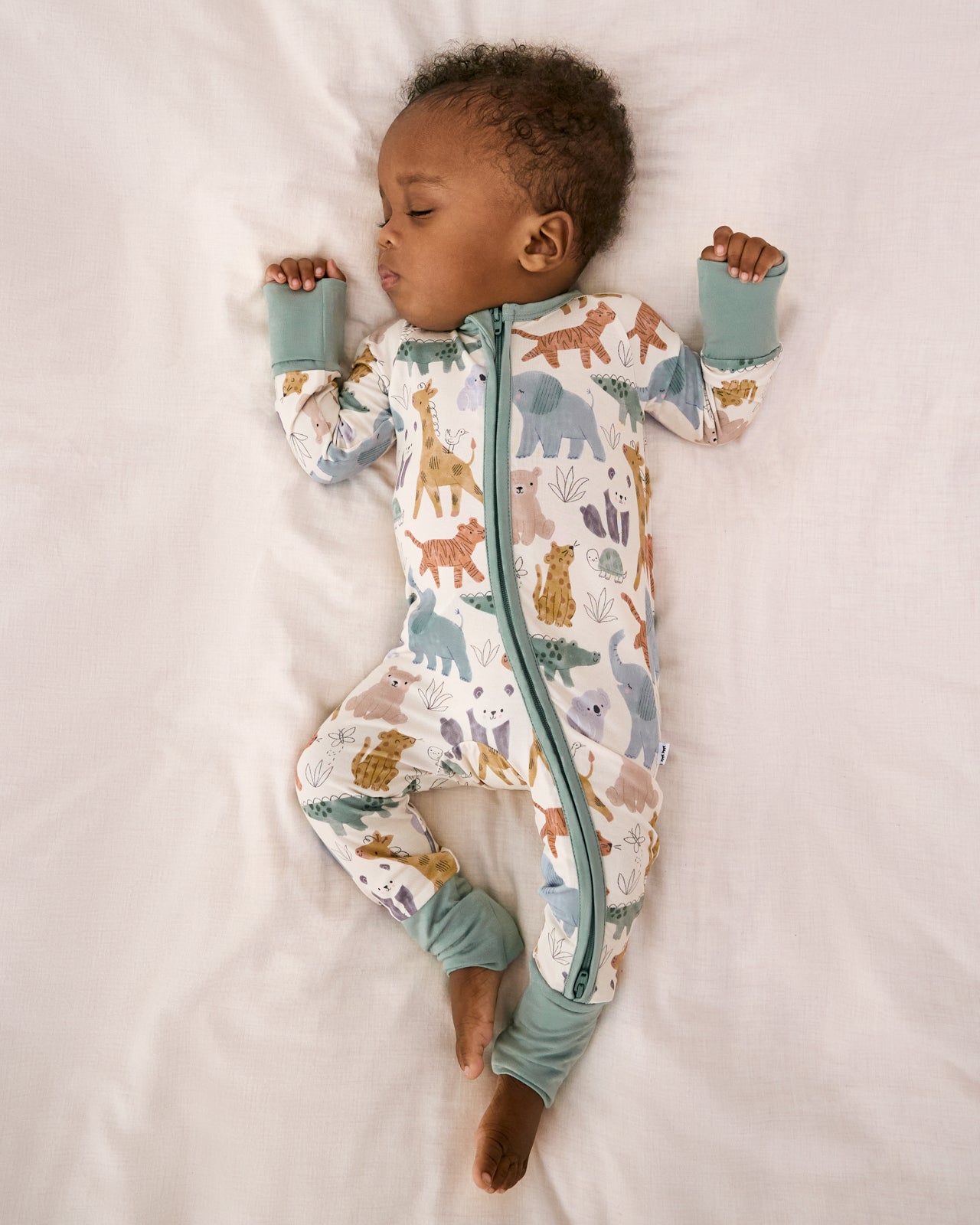 Aerial view of sleeping baby wearing the Sweet Safari Zippy