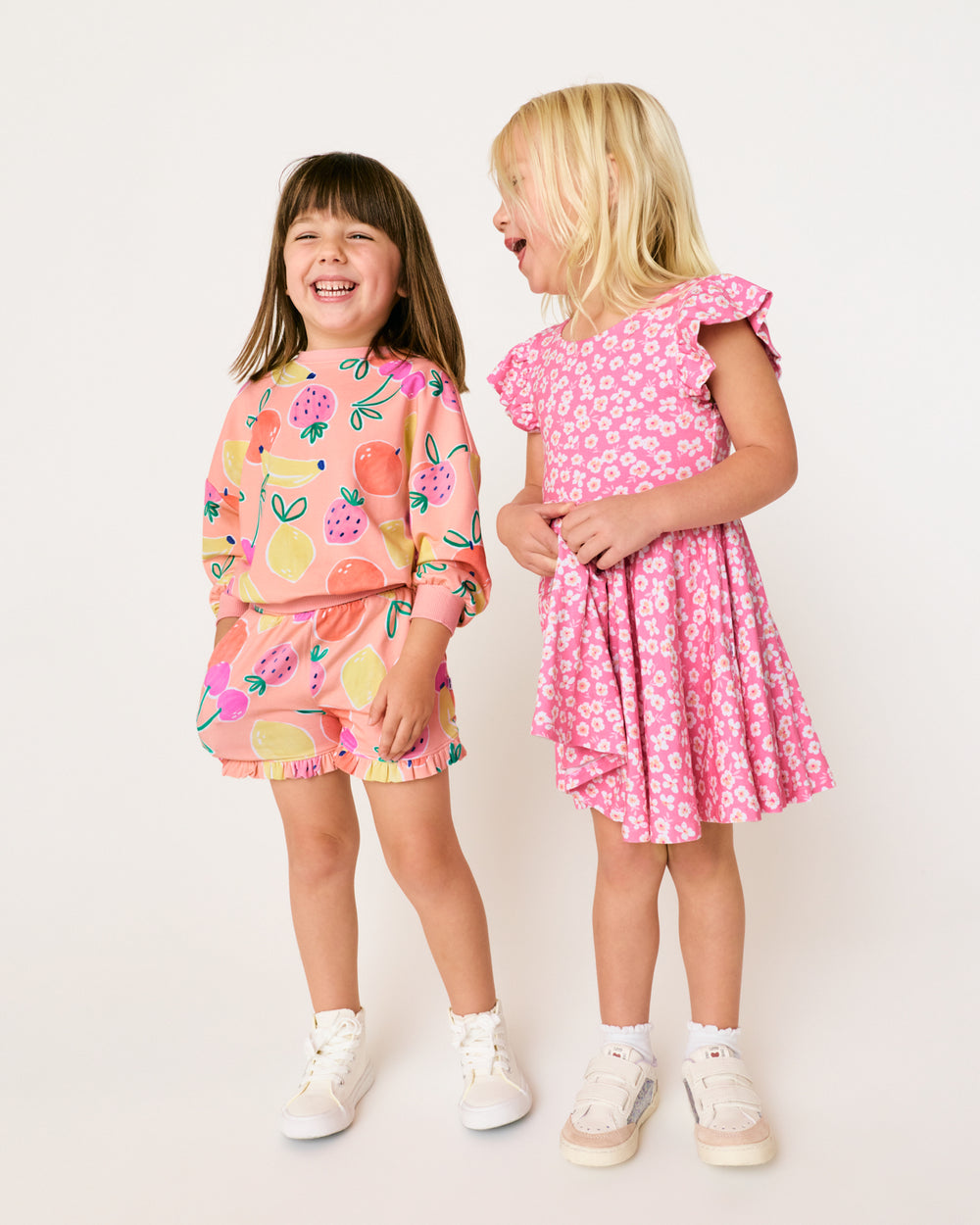 Two girls wearing styles from the Play Spring Capsule