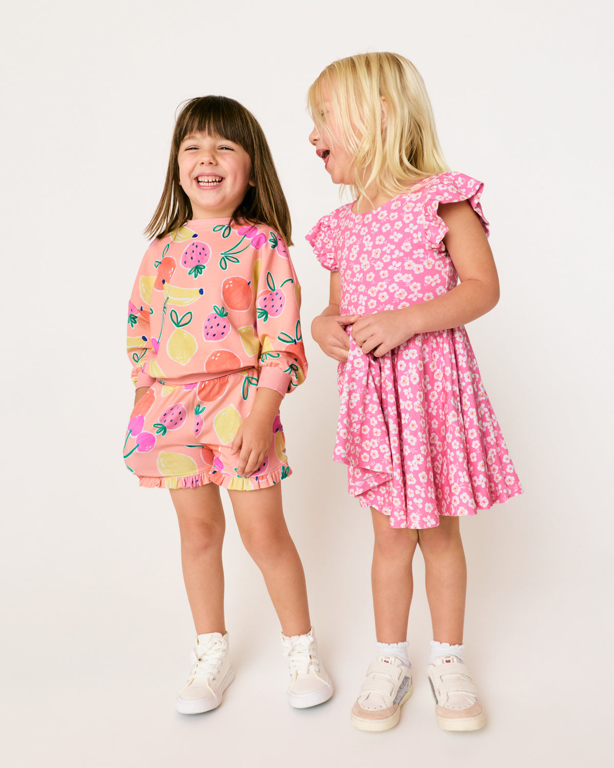 Two girls wearing styles from the Play Spring Capsule