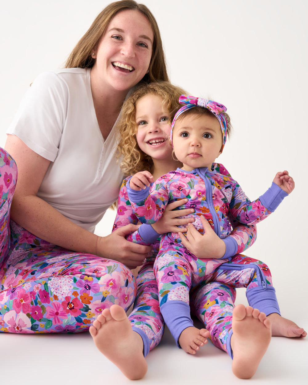 Mother and two children wearing matching Sweet Sprigs pajamas