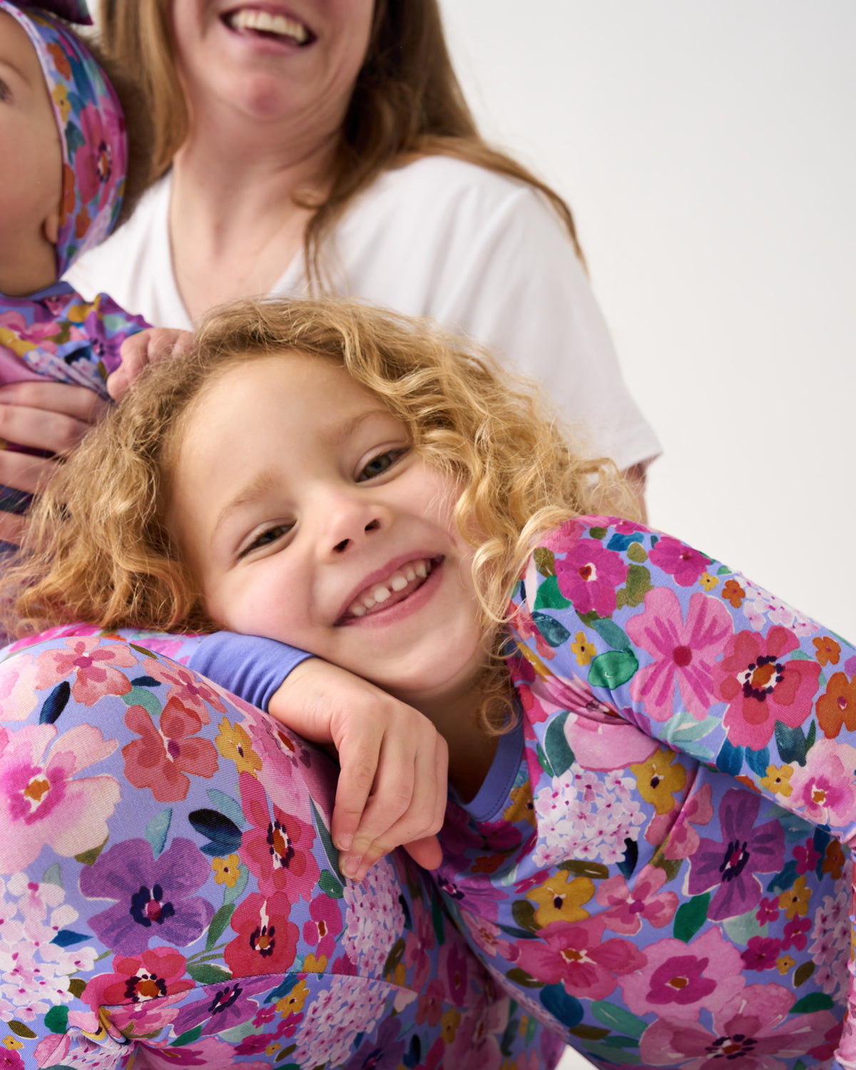 Girl wearing the Sweet Sprigs Two-Piece Pajama Set leaning on her Mother