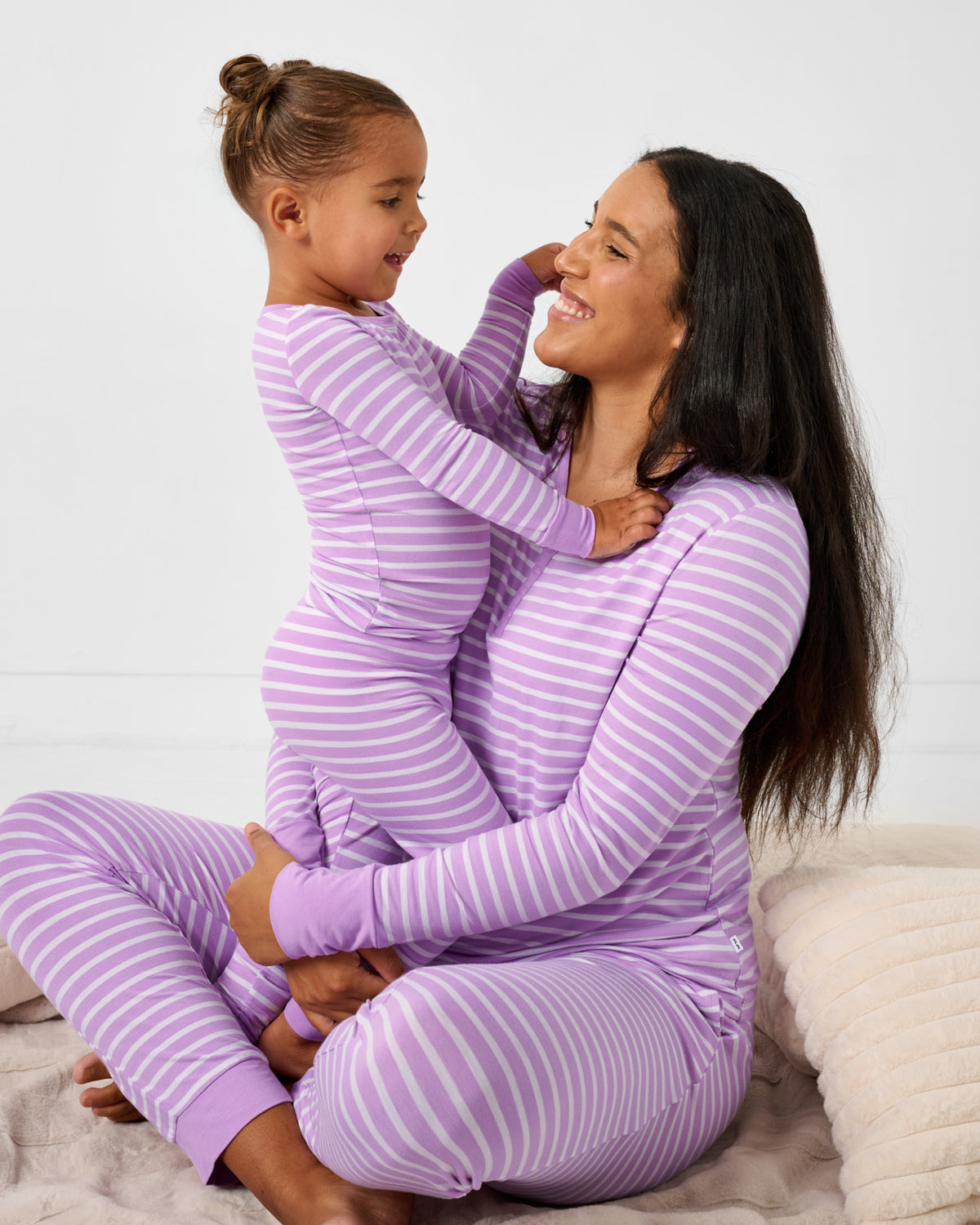 Mother and daughter wearing matching Sweet Orchid Stripe bamboo pajamas