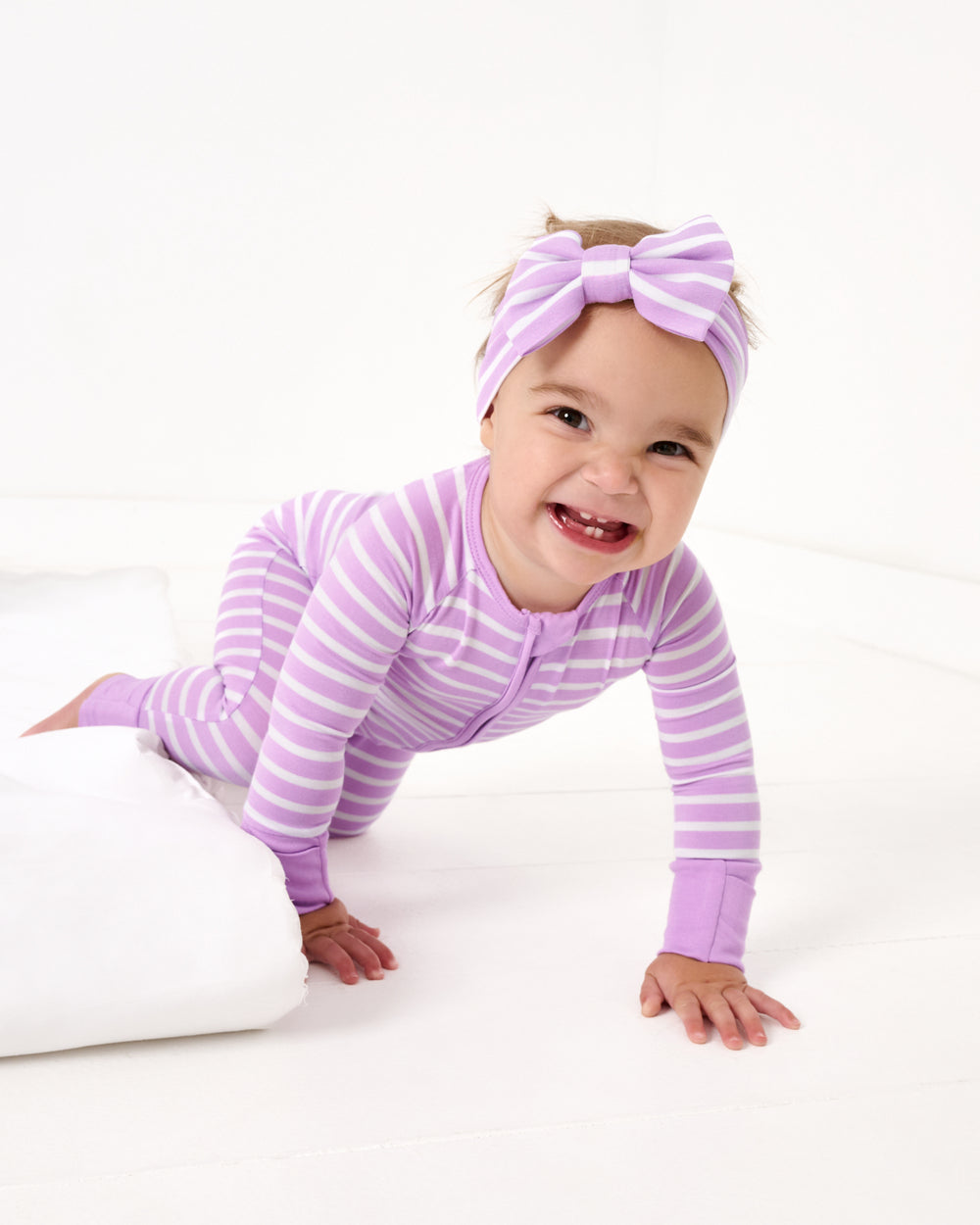 Crawling baby wearing the Sweet Orchid Stripe Zippy and Headband