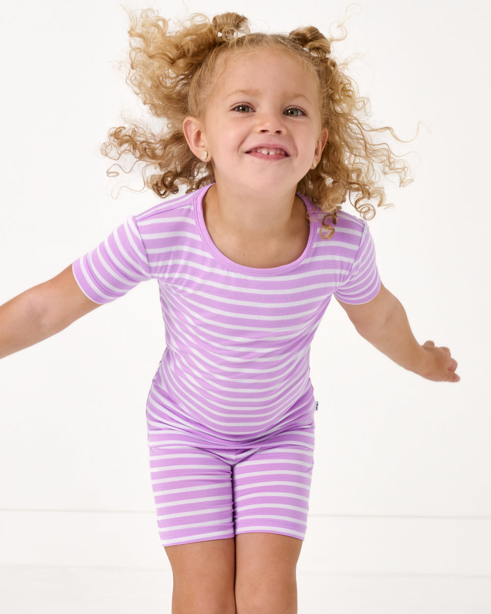 Close up of girl wearing the Sweet Orchid Stripe Two-Piece Short Sleeve & Shorts Pajama Set