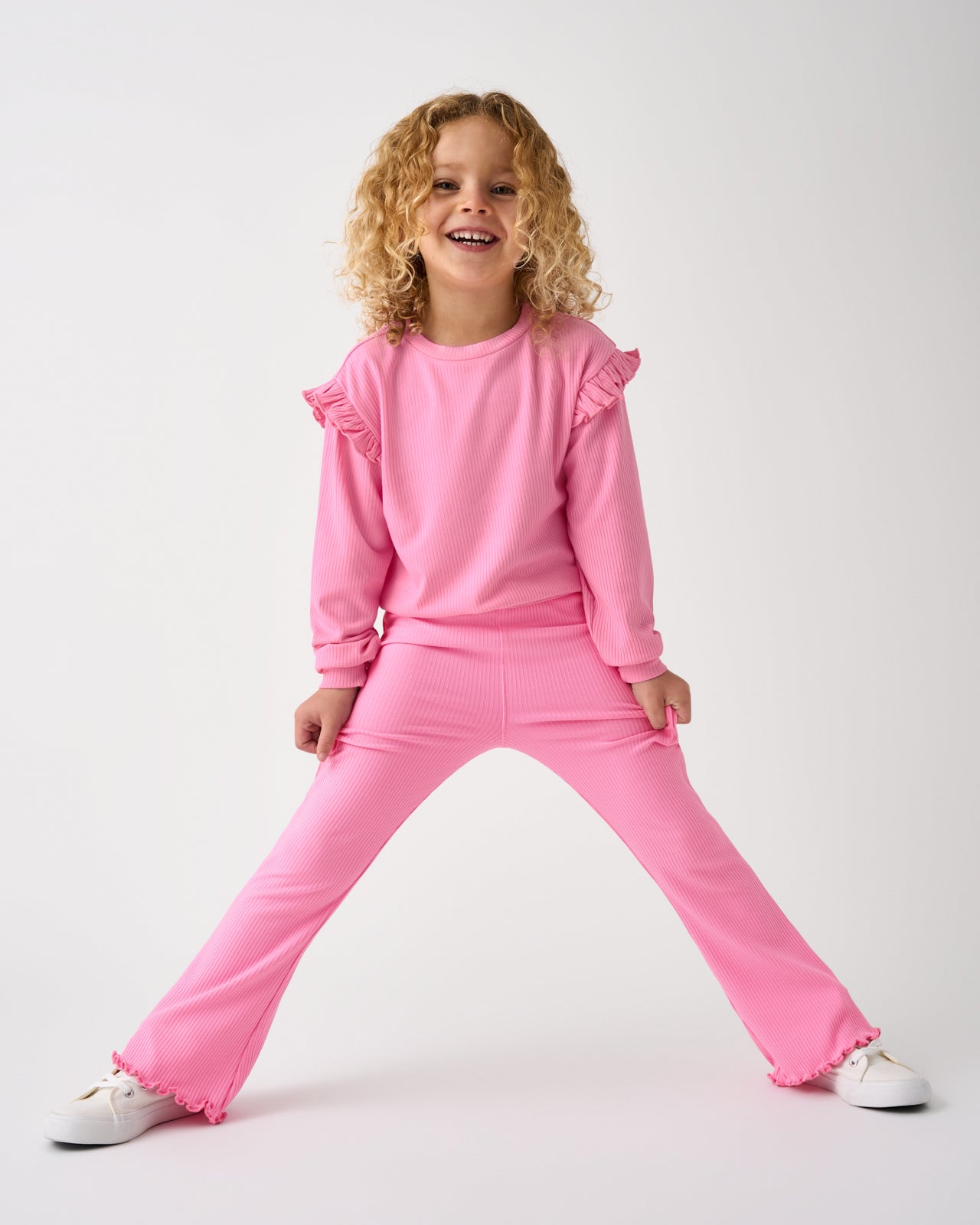 Girl wearing the Sweet Pink Ribbed Flare Pants and Crewneck