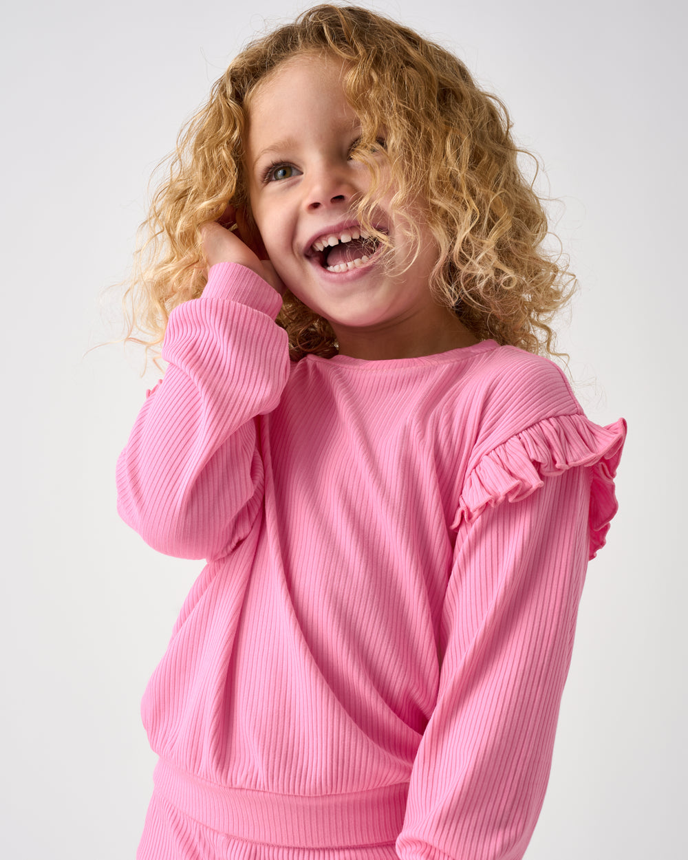 Close up of girl wearing the Sweet Pink Ribbed Flutter Crewneck