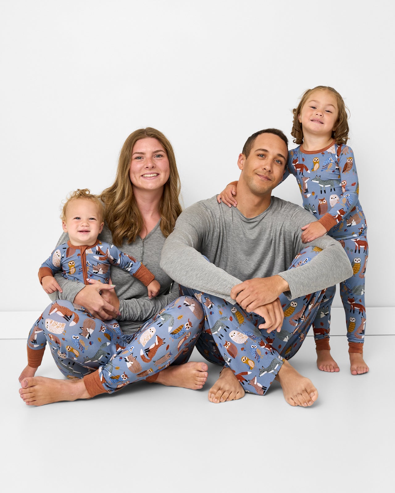 Family of four wearing matching Twilight Pals bamboo pajamas