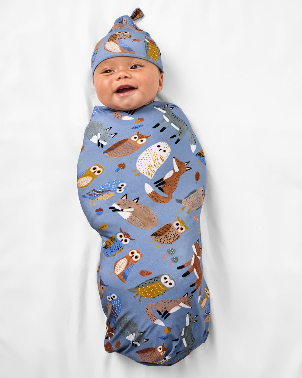 Baby wearing the Twilight Pals Swaddle & Hat Set