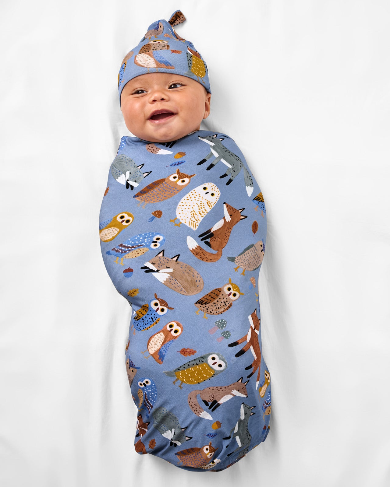 Baby wearing the Twilight Pals Swaddle & Hat Set