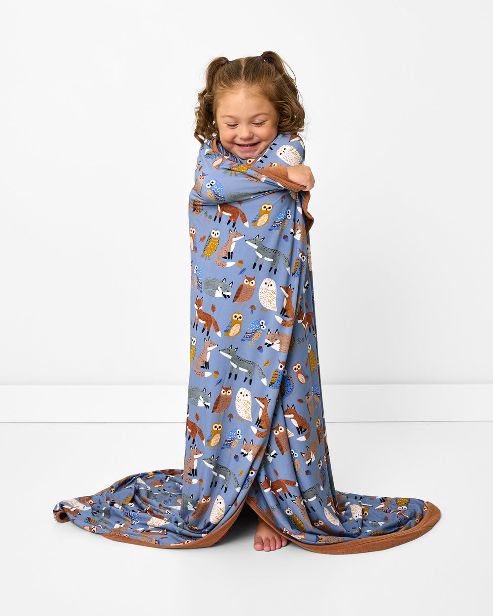 Standing girl wrapped in the Twilight Pals Large Cloud Blanket®