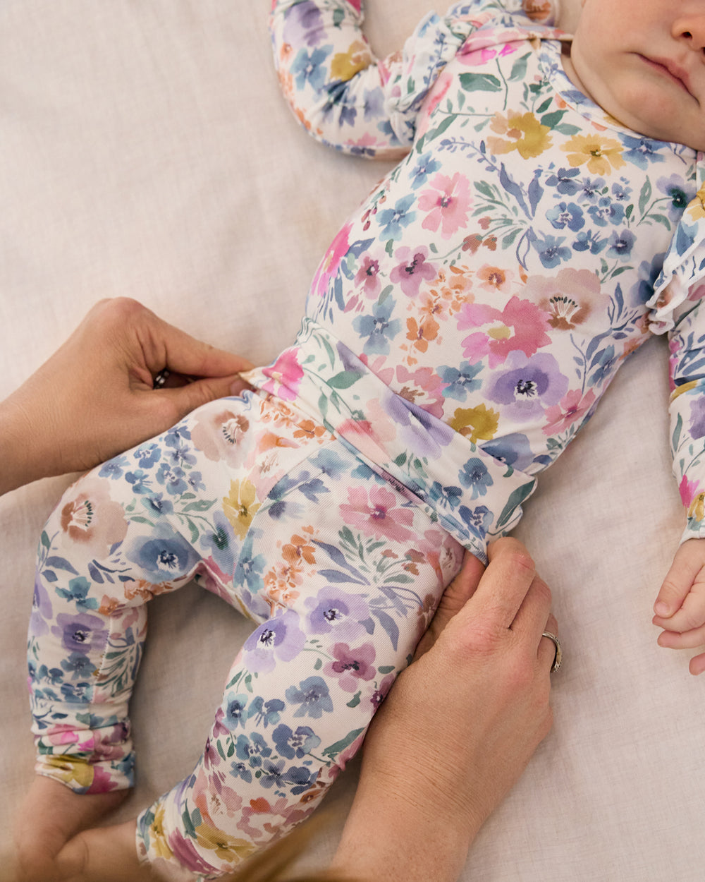 Adult adjusting the waist band on the Tiny Blooms Fold-Over Legging