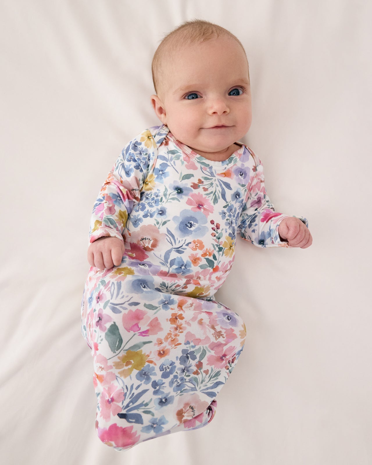 Aerial view of baby wearing the Tiny Blooms Infant Gown