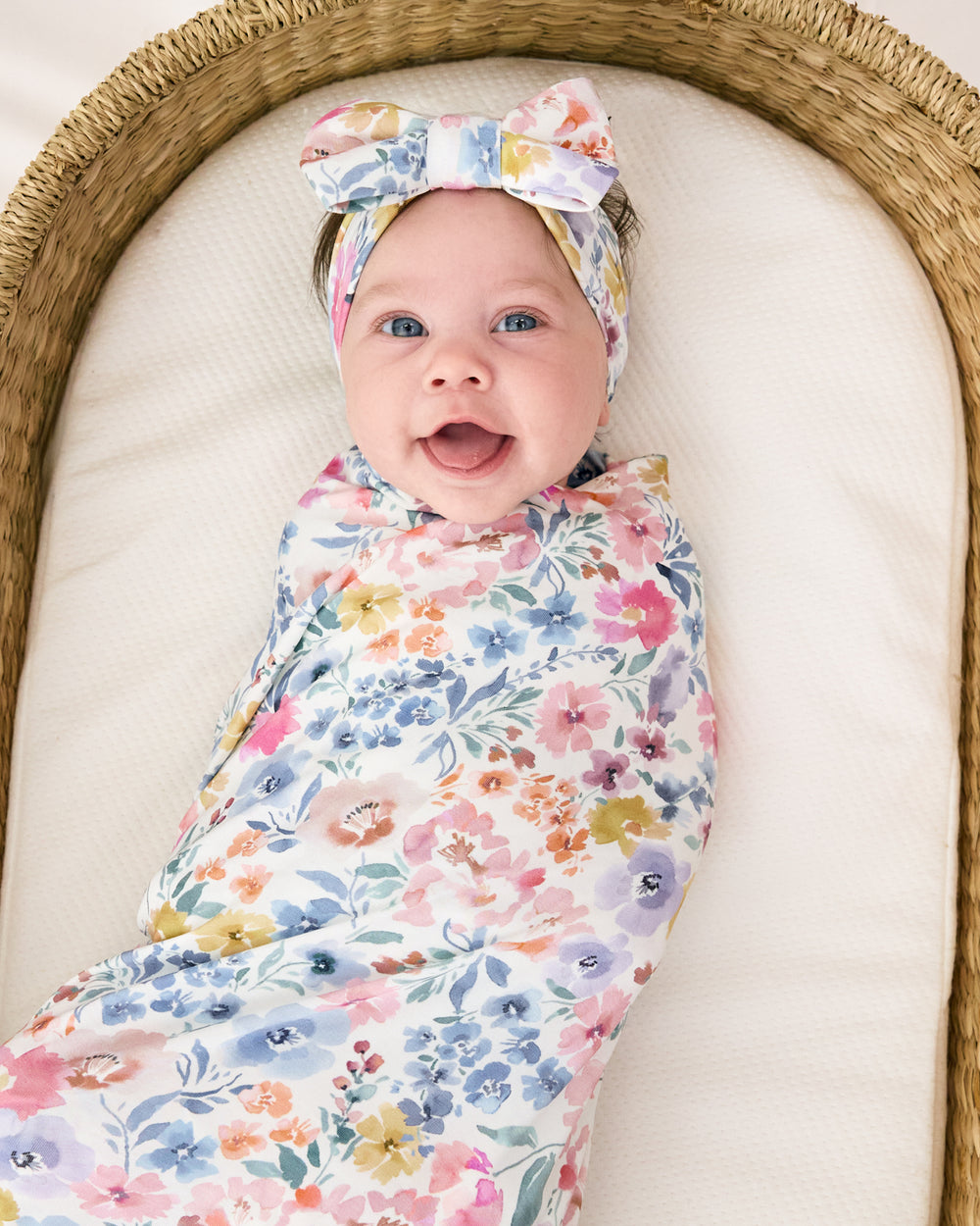 Alternate aerial view of baby in the Tiny Blooms Swaddle & Luxe Bow Headband Set
