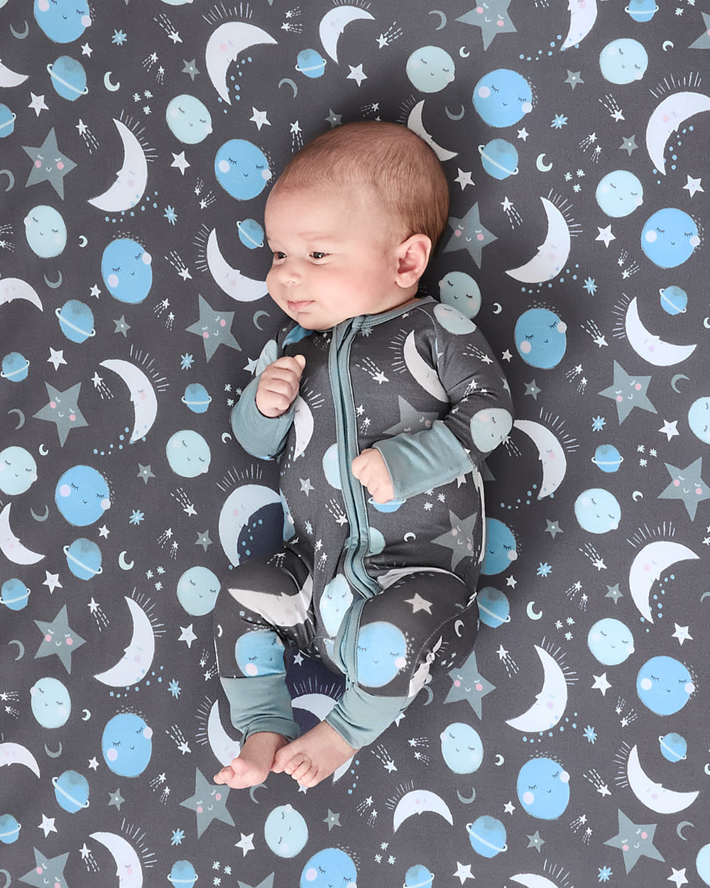 Alternate baby laying on the Blue To the Moon & Back Fitted Crib Sheet