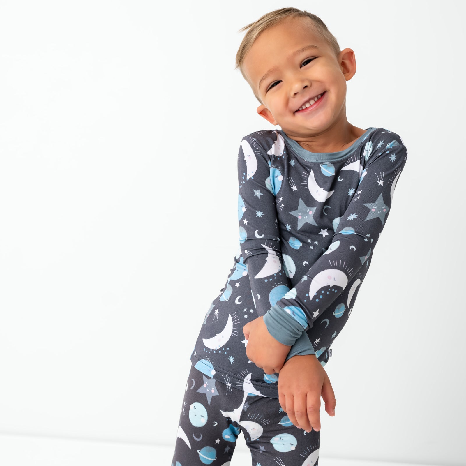 Standing child wearing the Blue To the Moon & Back Two-Piece Pajama Set