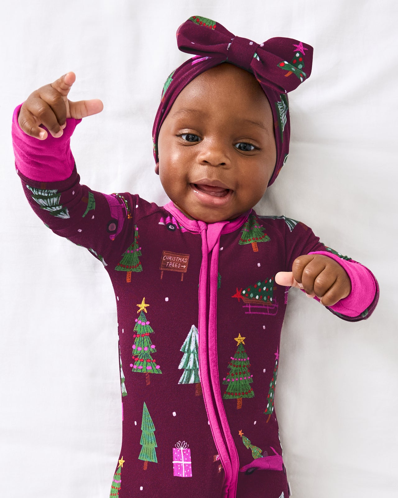 Close up of baby wearing the Cranberry Tree Traffic Zippy 