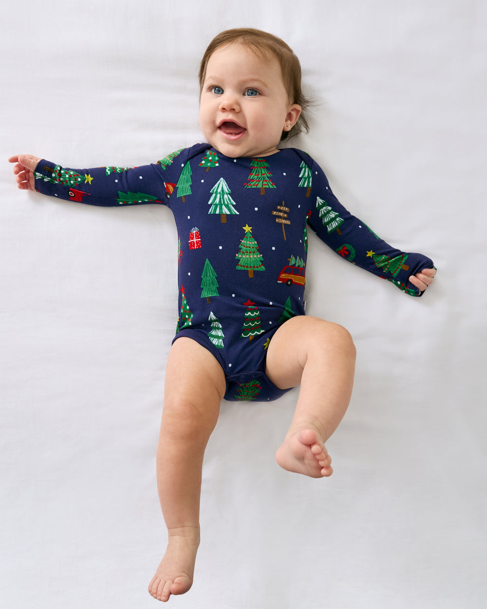 Ariel view of baby wearing the Navy Tree Traffic Bodysuit