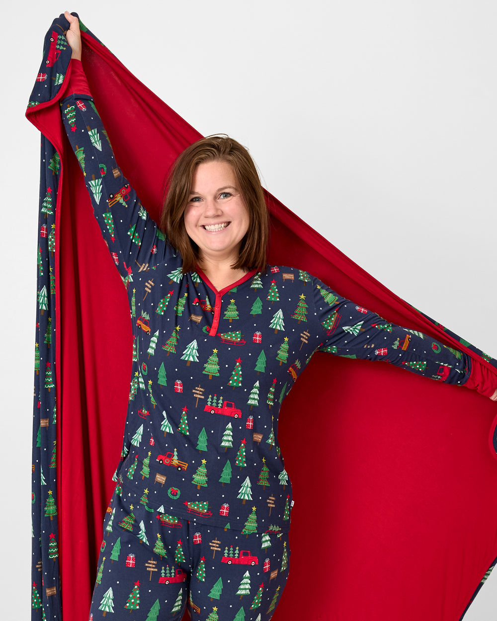 Woman holding up the Navy Tree Traffic Oversized Cloud Blanket®