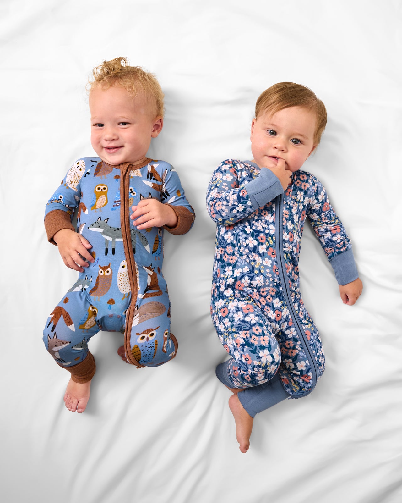 Aerial view of two babies wearing Twilight Pals and Petite Petals Zippys