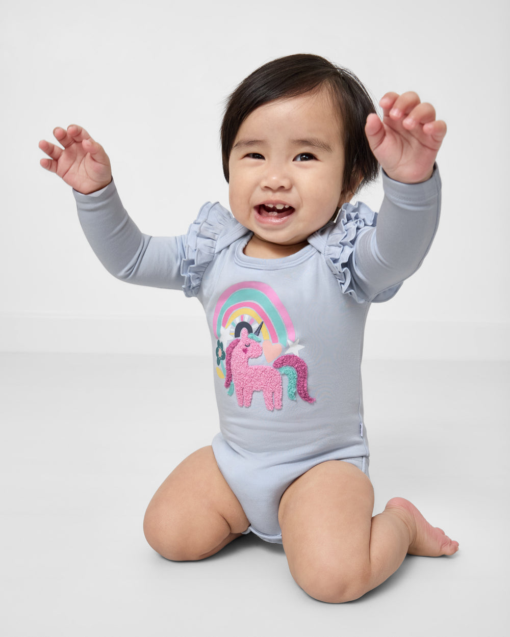 Posing child wearing the Unicorn Flutter Bodysuit