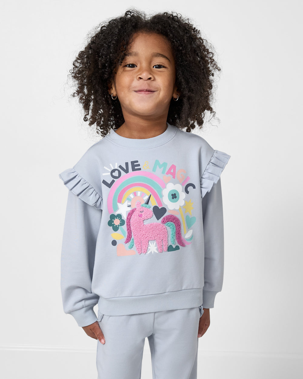 Girl wearing the Unicorn Ruffle Crewneck