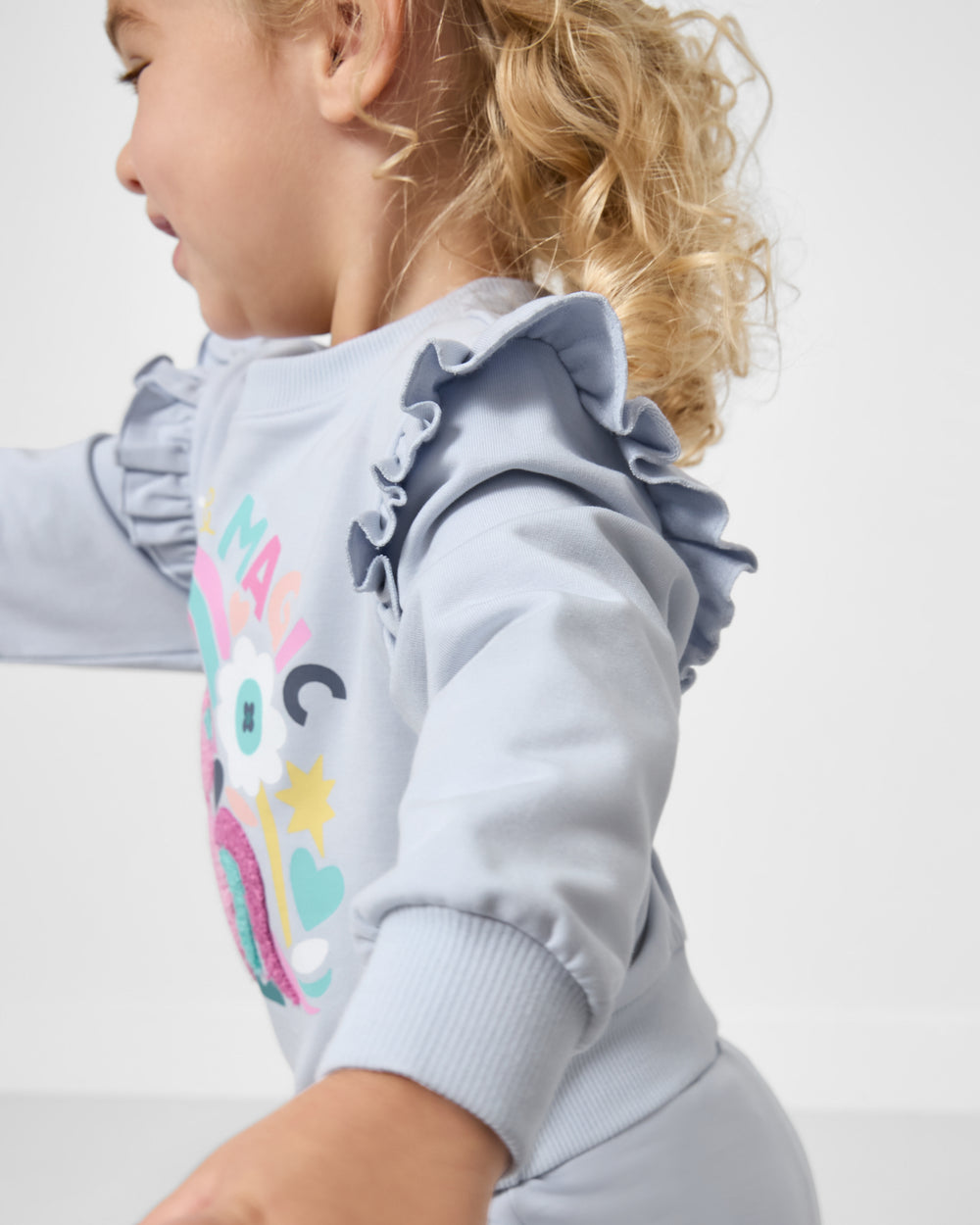 Close up of the ruffle detail on the Unicorn Ruffle Crewneck