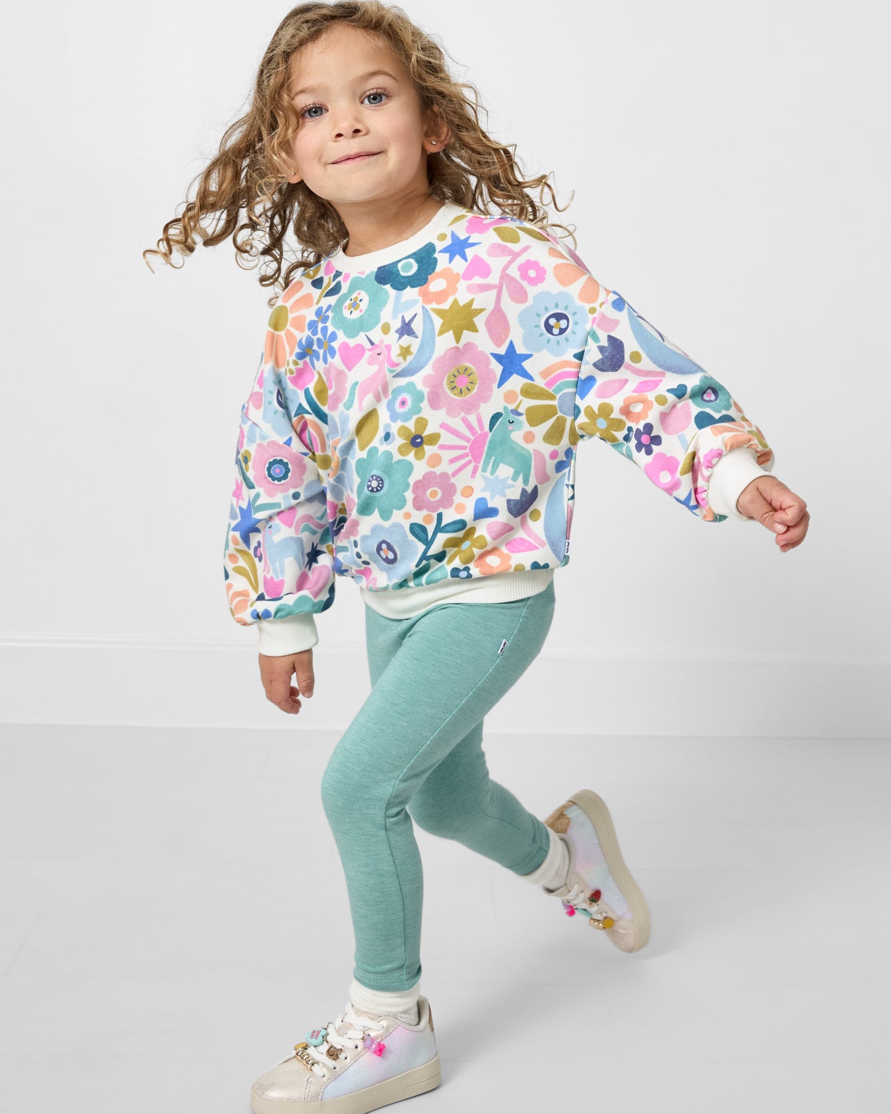 Girl in motion wearing the Unicorn Blossoms Drop Shoulder Crewneck
