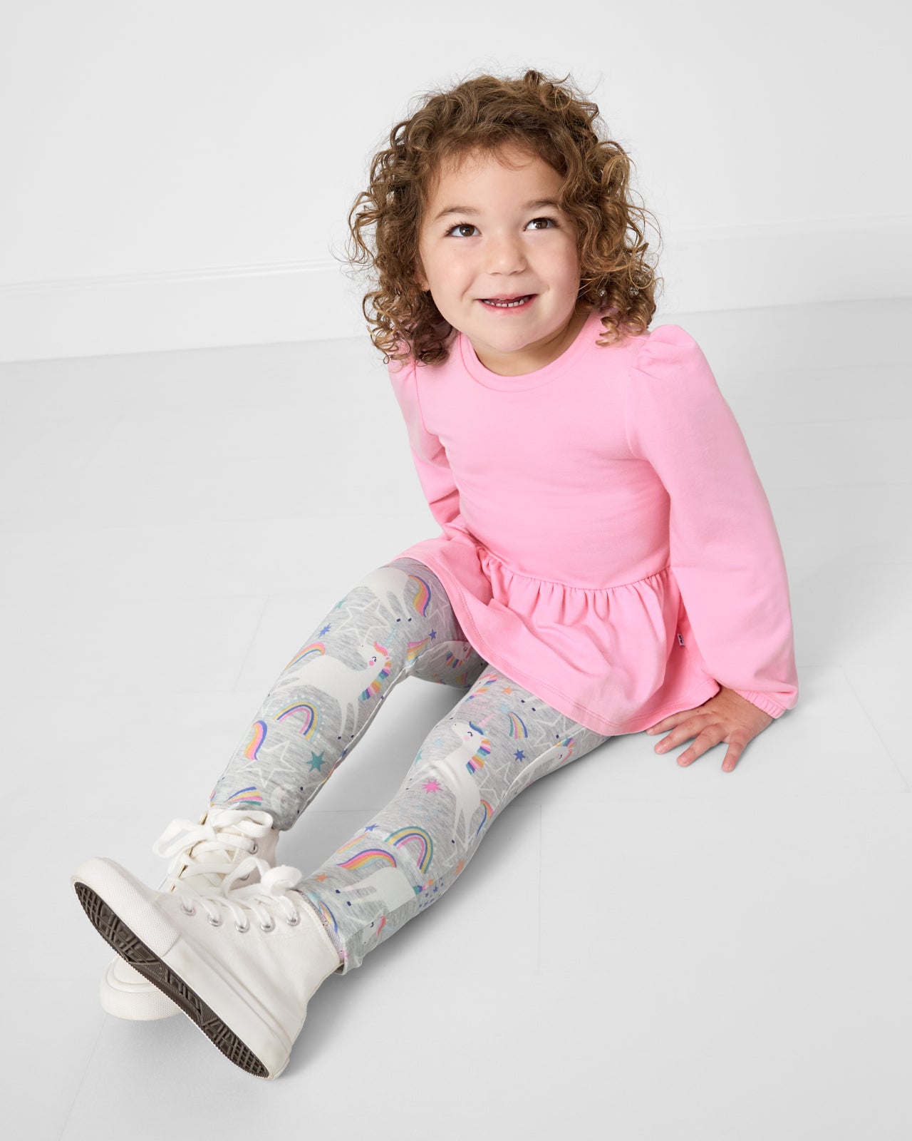 Sitting girl wearing the Unicorn Dance Legging