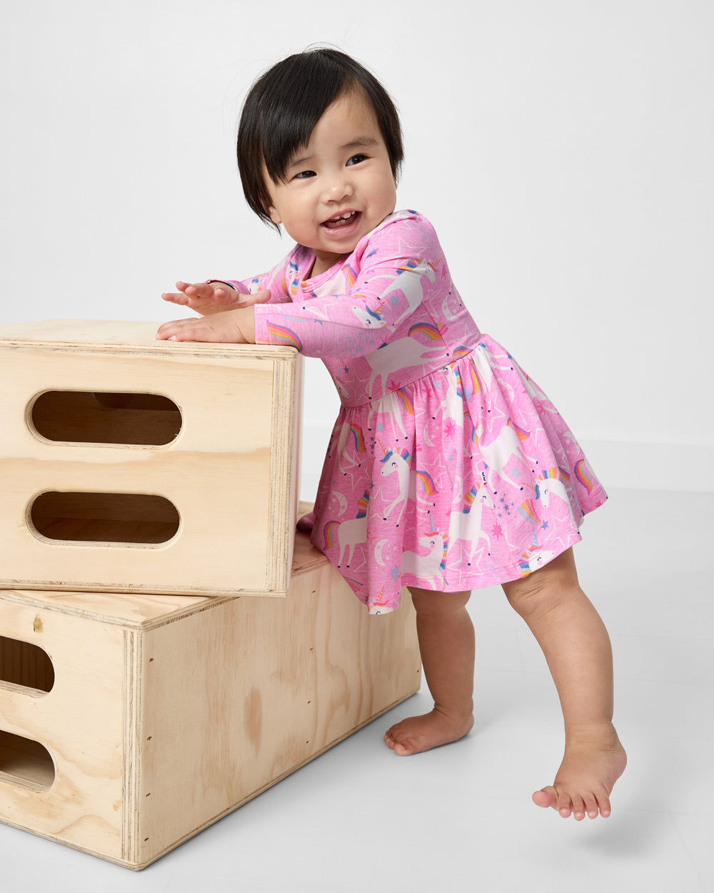 Standing baby wearing the Unicorn Dance Twirl Dress with Bodysuit
