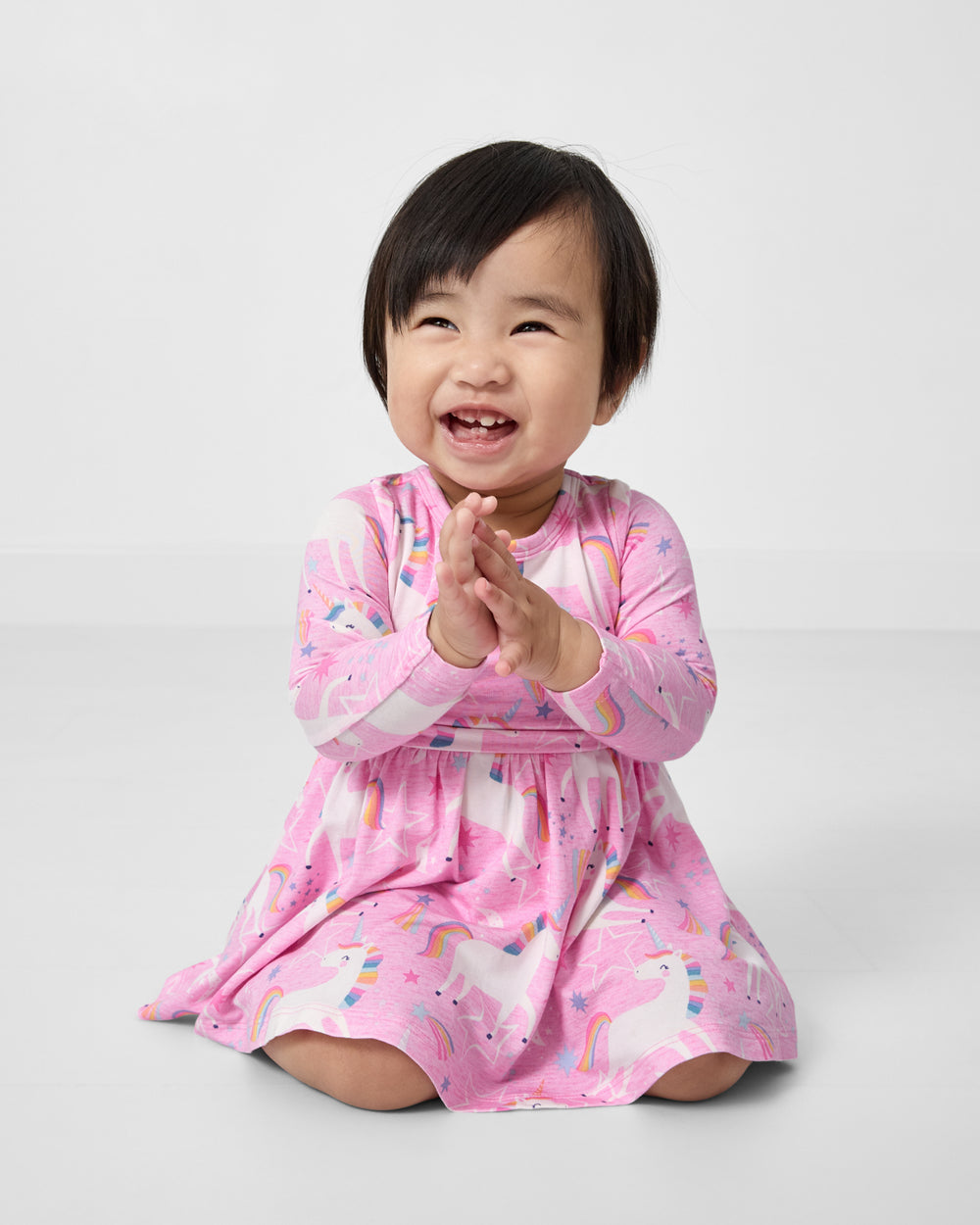 Clapping baby wearing the Unicorn Dance Twirl Dress with Bodysuit