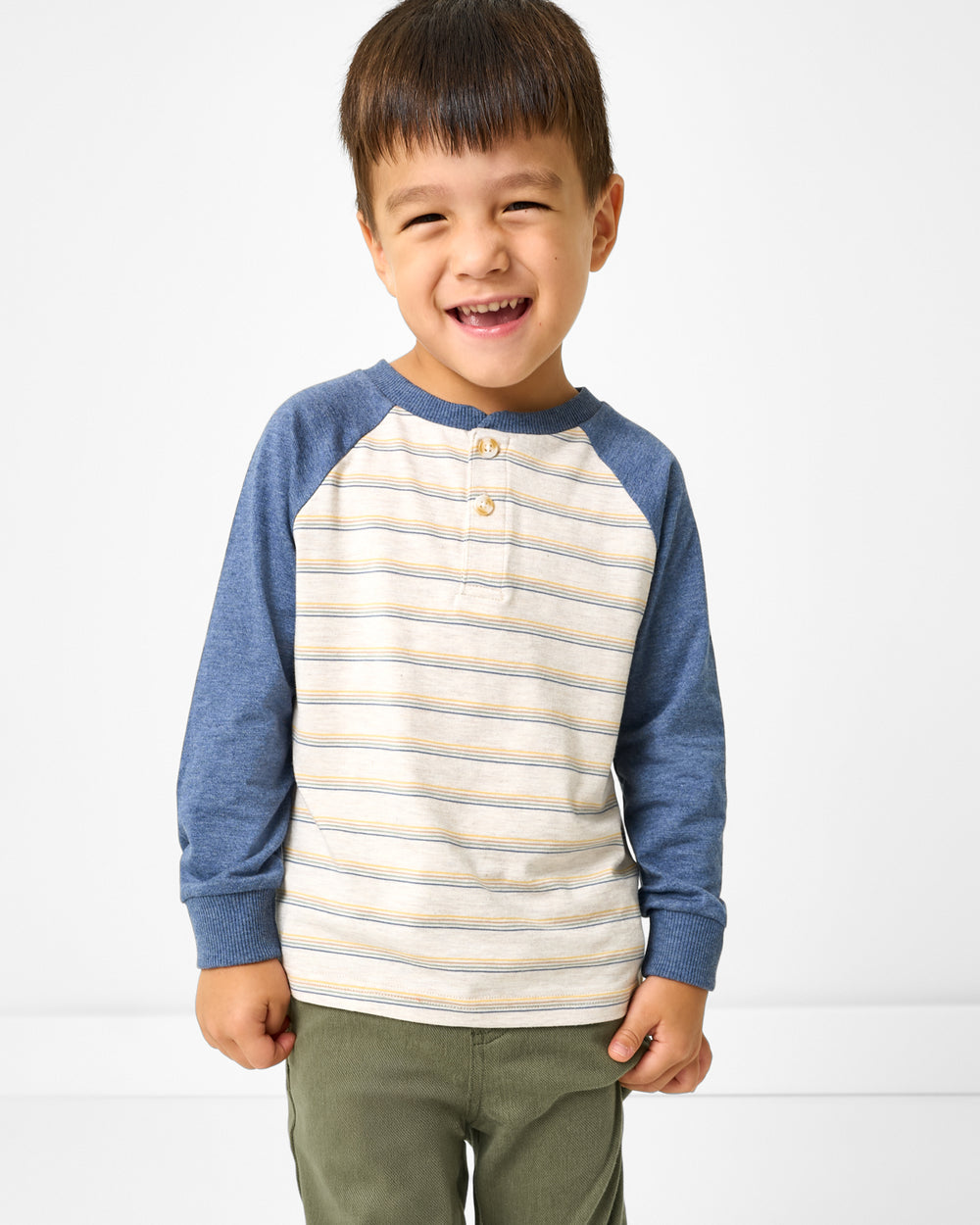 Boy wearing the Vintage Navy Heather Stripe Raglan Henley Tee