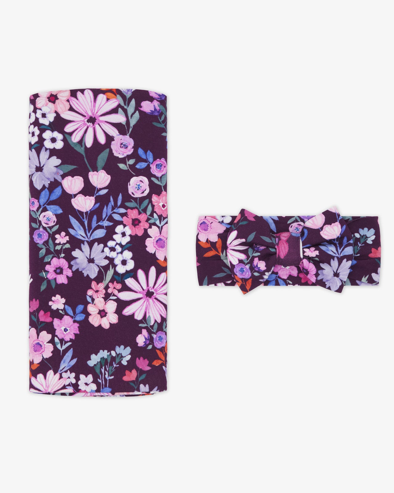 Flat lay of the Violet Meadow Swaddle & Luxe Bow Headband Set