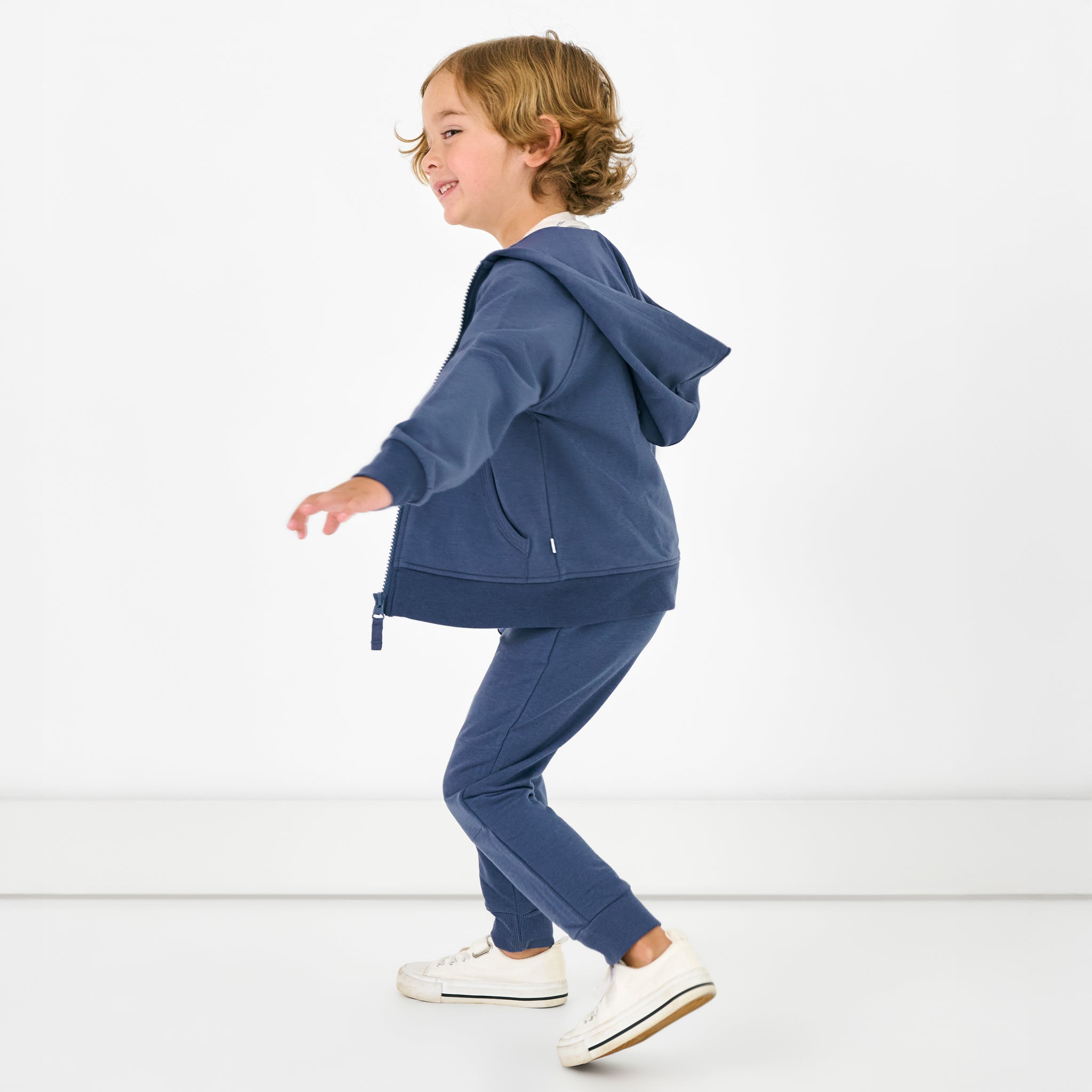 Child in motion wearing the Vintage Navy Jogger and Hoodie