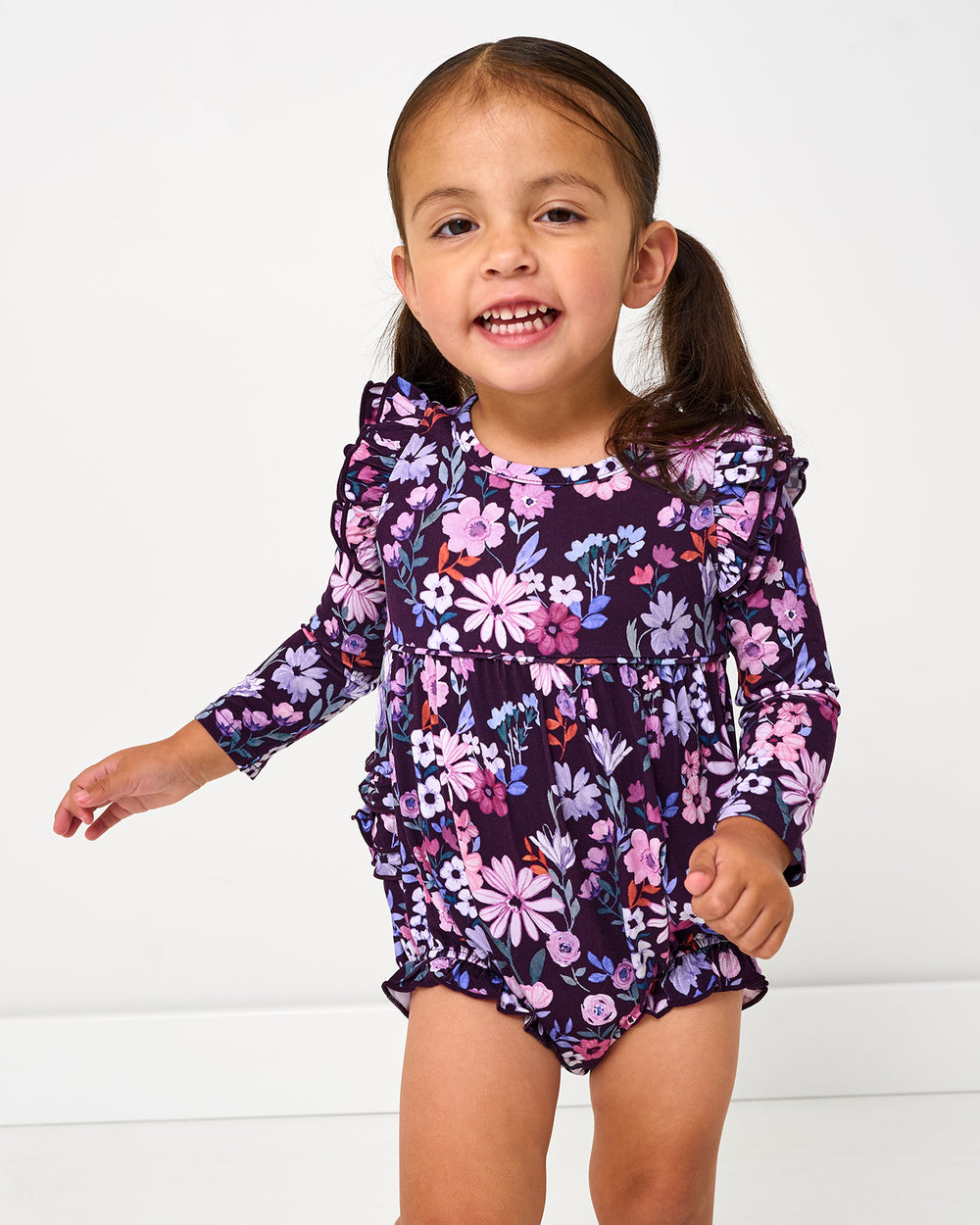Girl wearing the Violet Meadow Bubble Romper