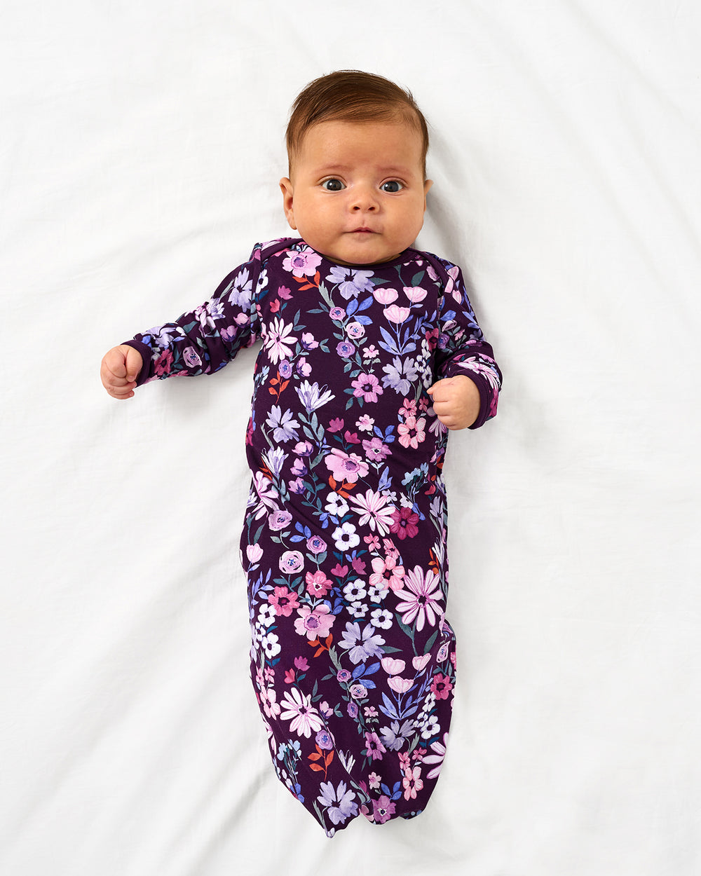 Aerial view of baby in the Violet Meadow Infant Gown