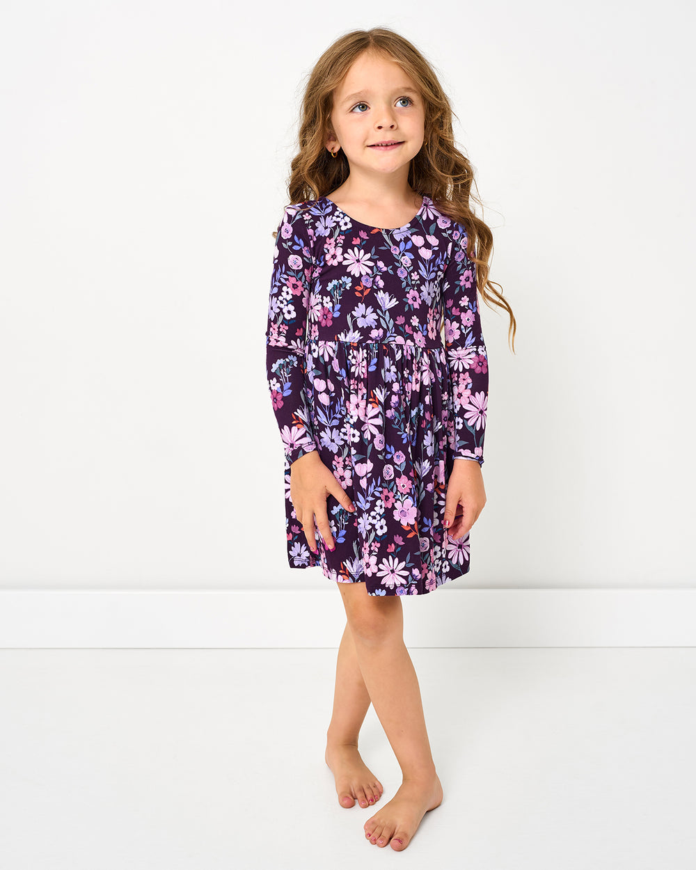 Standing girl wearing the Violet Meadow Bow Back Skater Dress