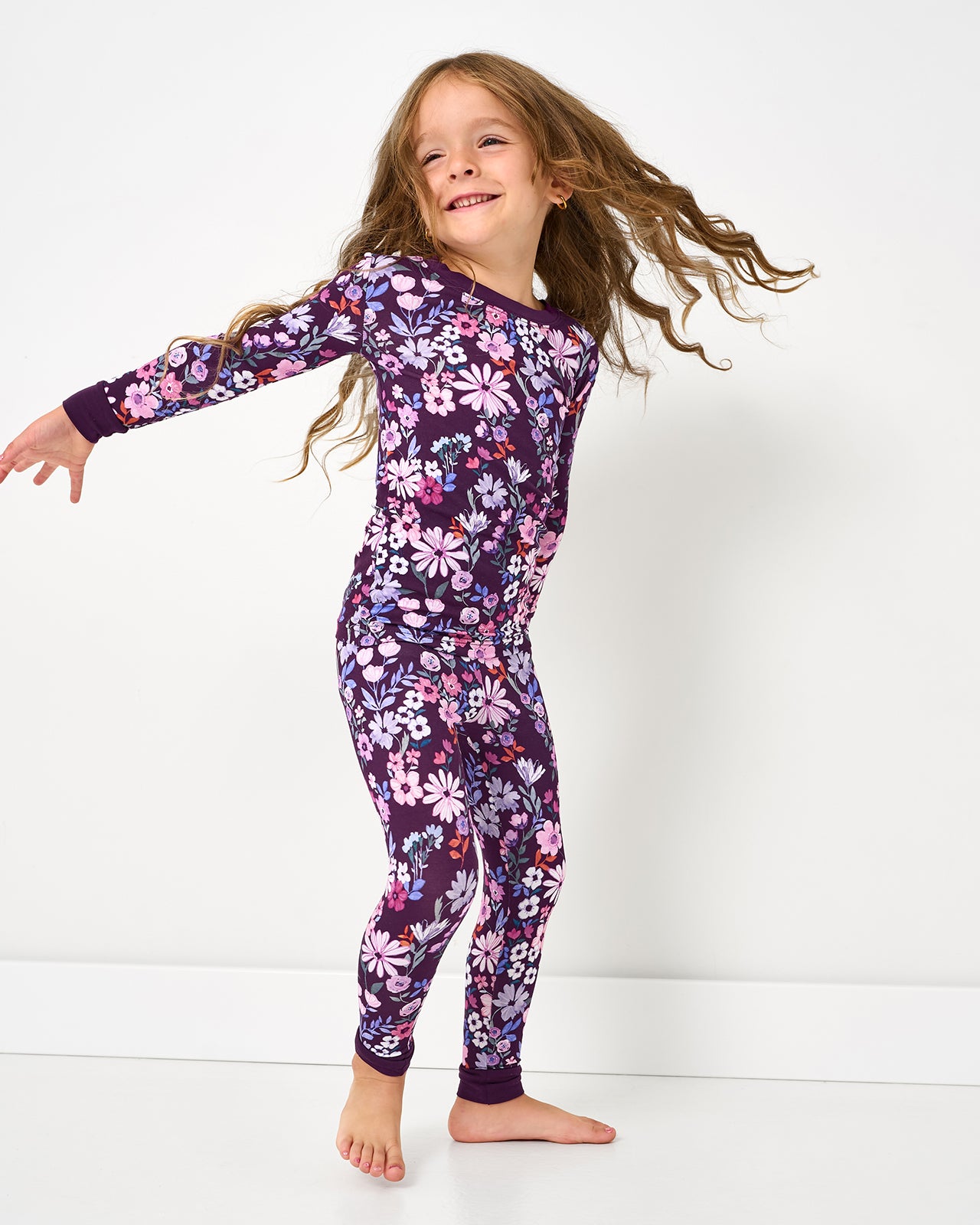 Child in motion wearing the Violet Meadow Two-Piece Pajama Set