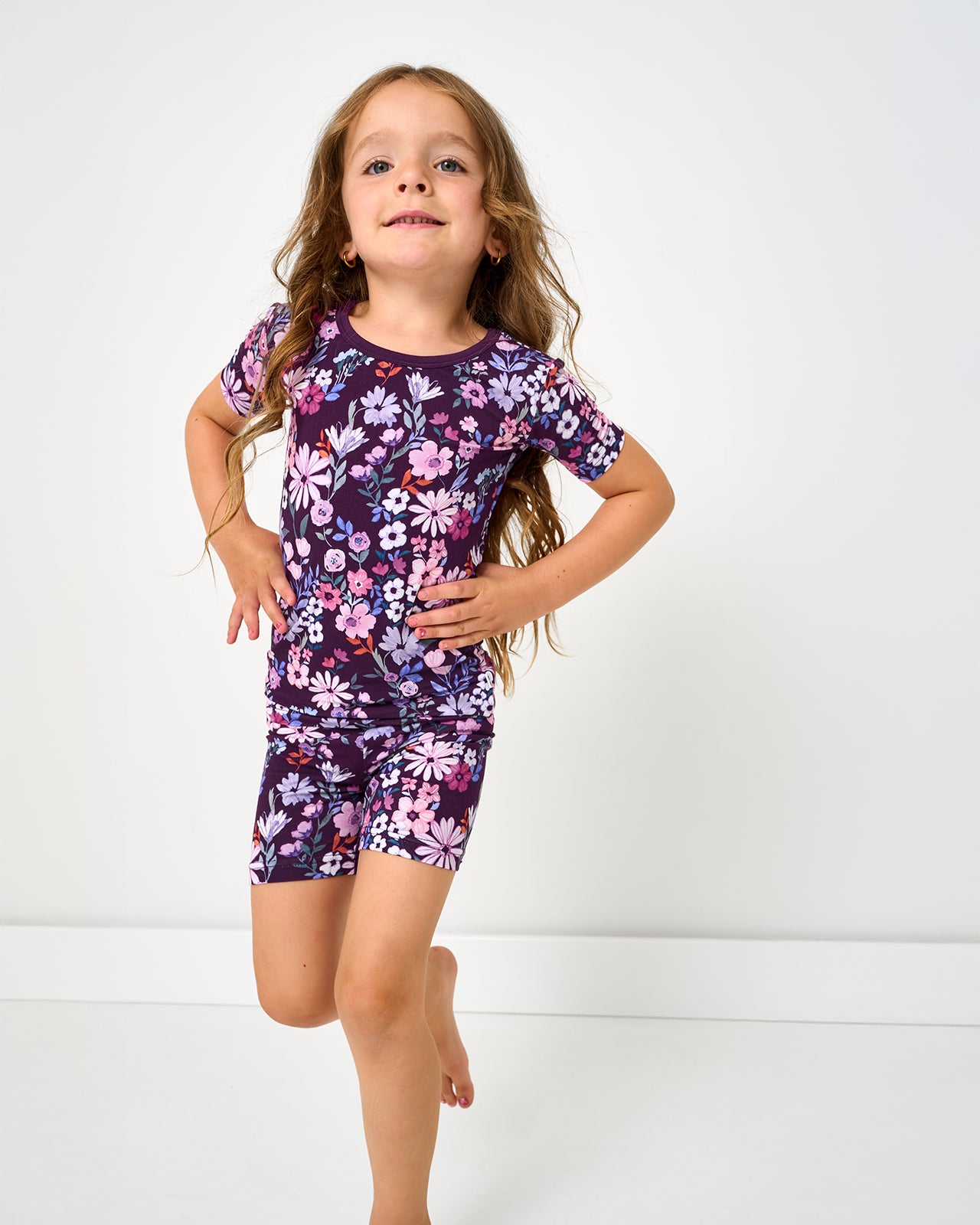 Girl in motion wearing the Violet Meadow Two-Piece Short Sleeve & Shorts Pajama Set