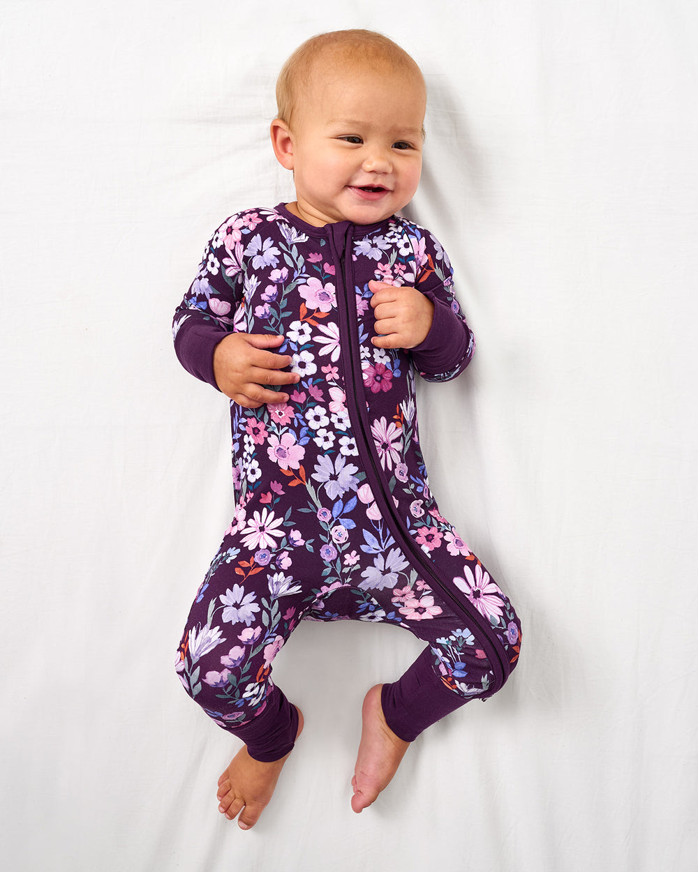 Aerial view of baby wearing the Violet Meadow Zippy