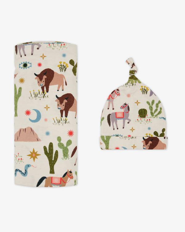 Flat lay of the Wild Frontier Swaddle & Hat Set