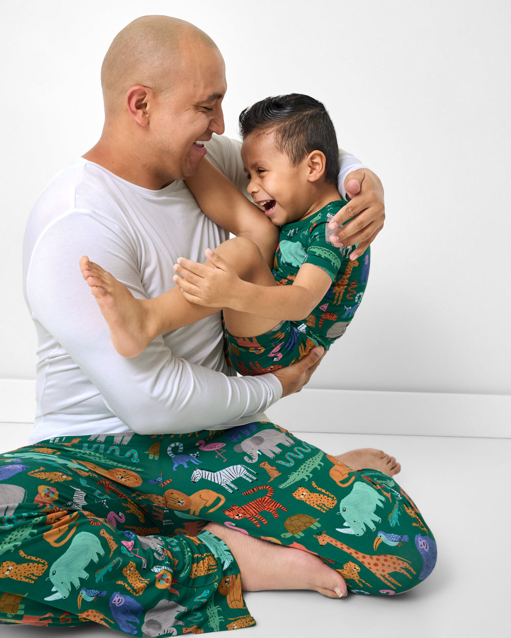 Father and son wearing matching Wild Zoo Bamboo Pajamas