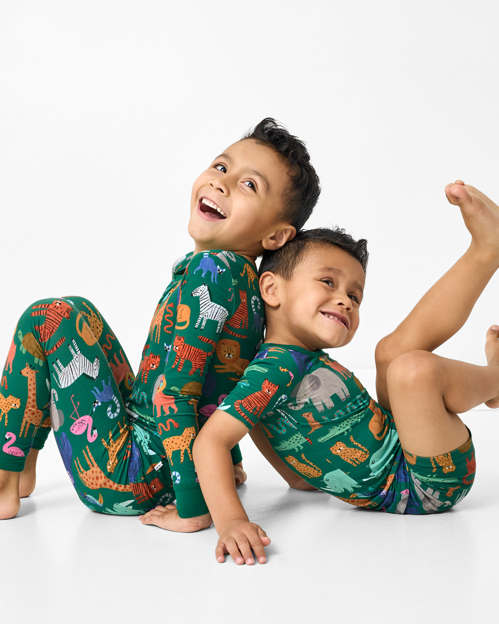 Two sitting boys wearing matching Wild Zoo Two-Piece PJ Sets