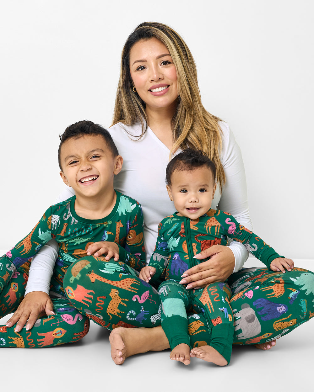 Mother and two children wearing matching Wild Zoo PJs