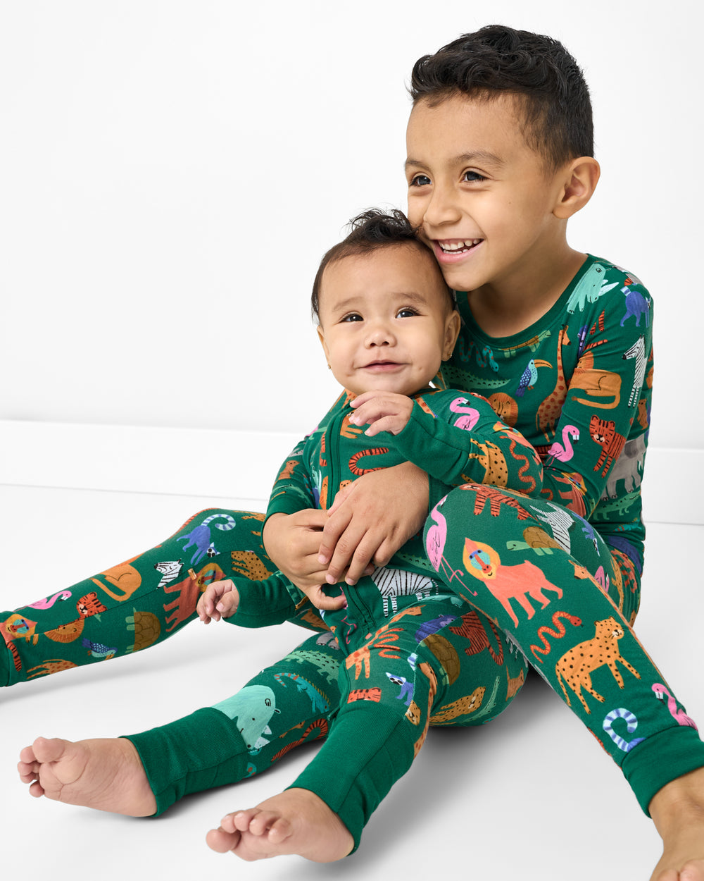 Two children wearing matching Wild Zoo Bamboo Pajamas