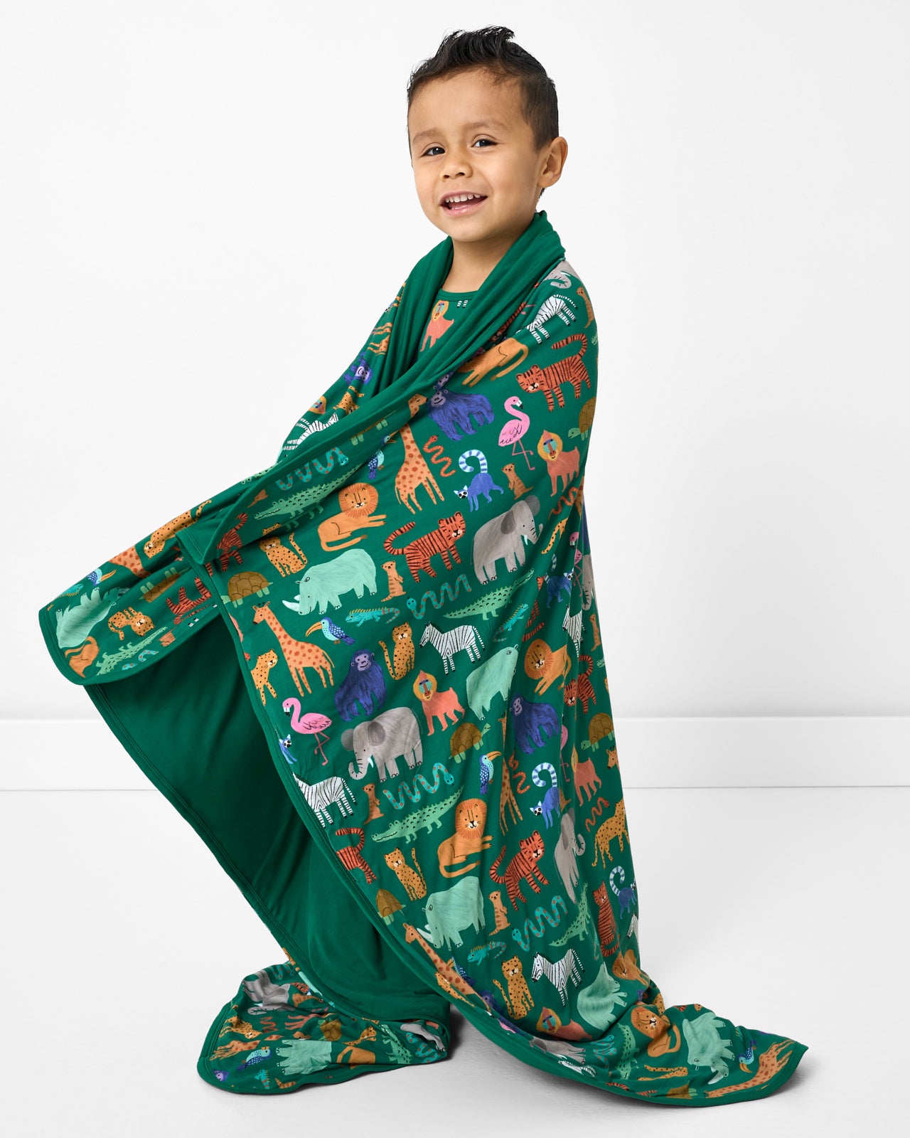 Standing boy wrapped in the Wild Zoo Large Cloud Blanket®