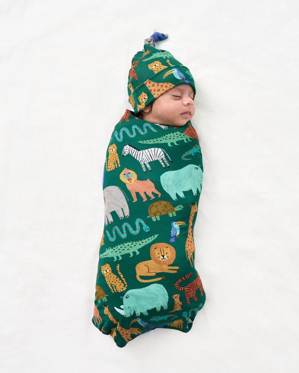 Aerial view of baby swaddled the the Wild Zoo Swaddle & Hat Set