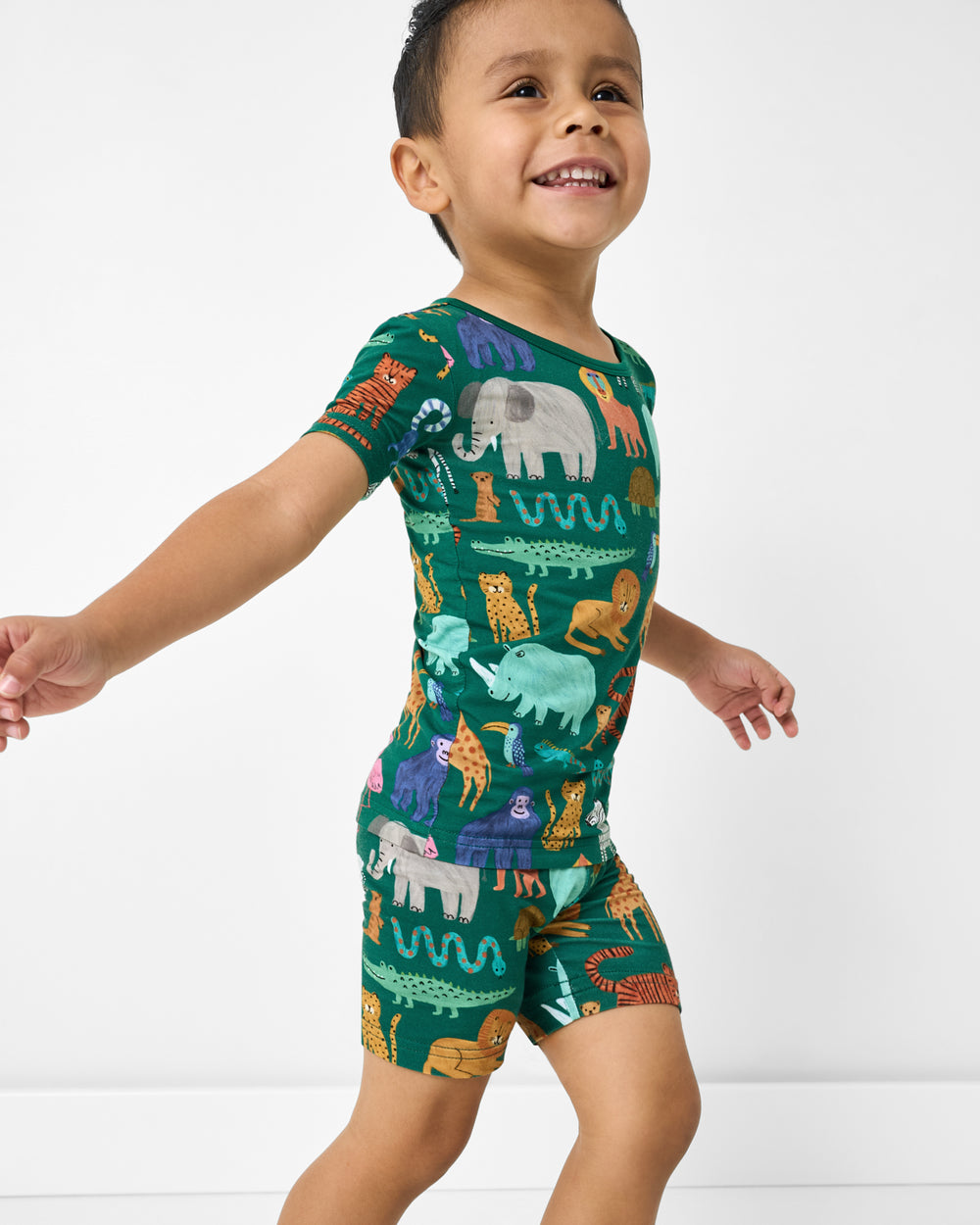 Boy wearing the Wild Zoo Two-Piece Short Sleeve & Shorts Pajama Set