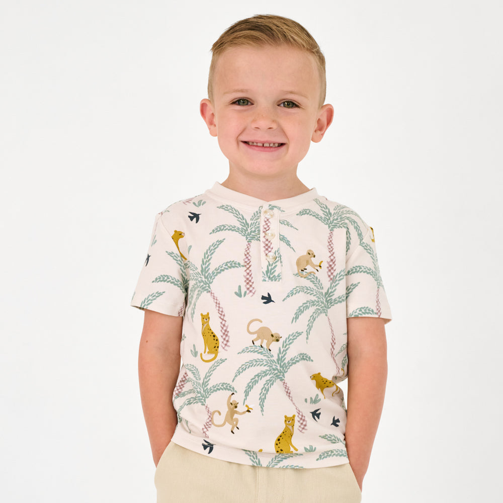 Standing child wearing the Wild Escape Henley Tee