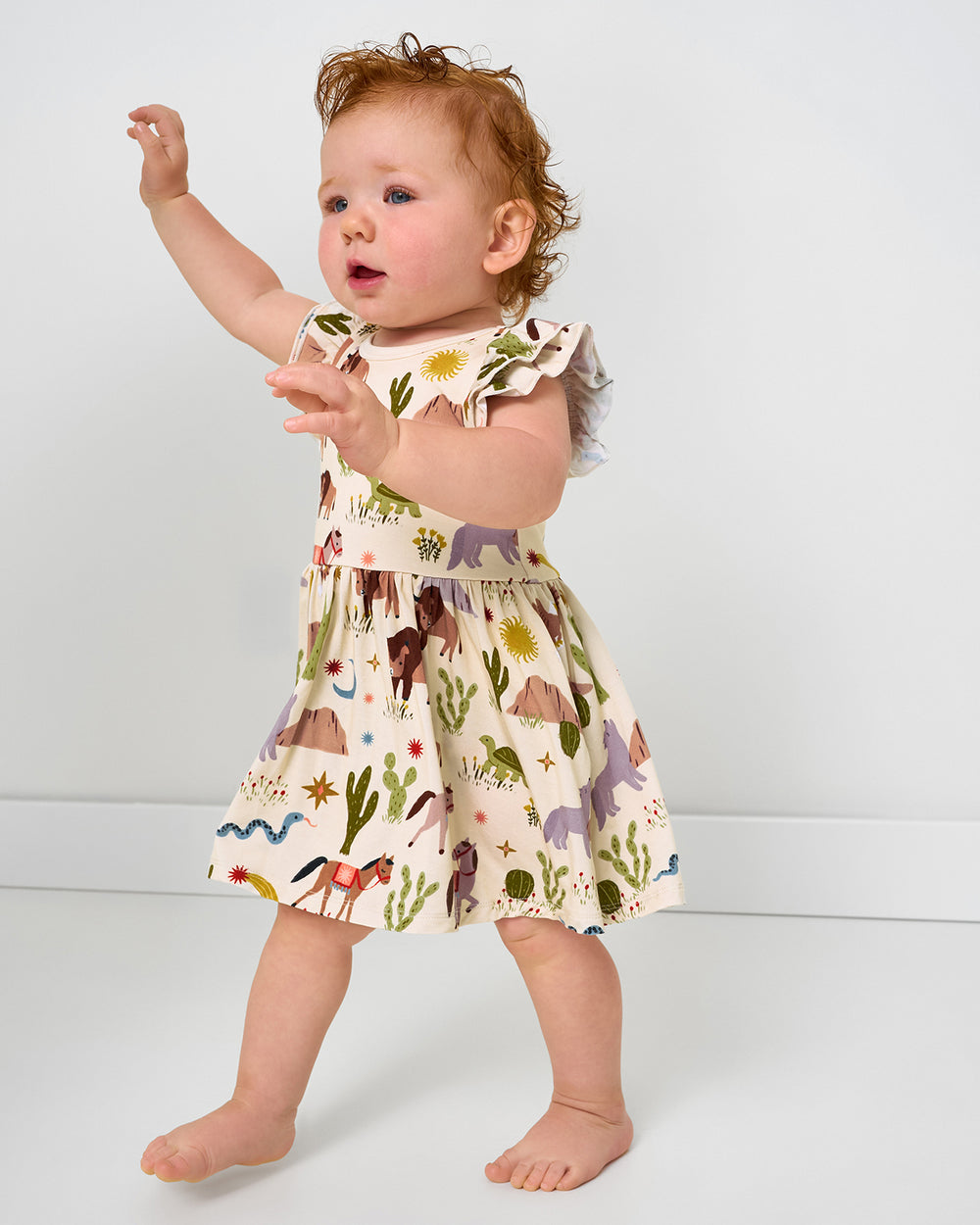 Toddler wearing the Wild Frontier Flutter Twirl Dress with Bodysuit