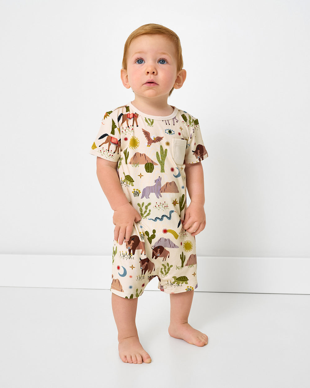 Standing boy wearing the Wild Frontier Pocket Shorty Romper